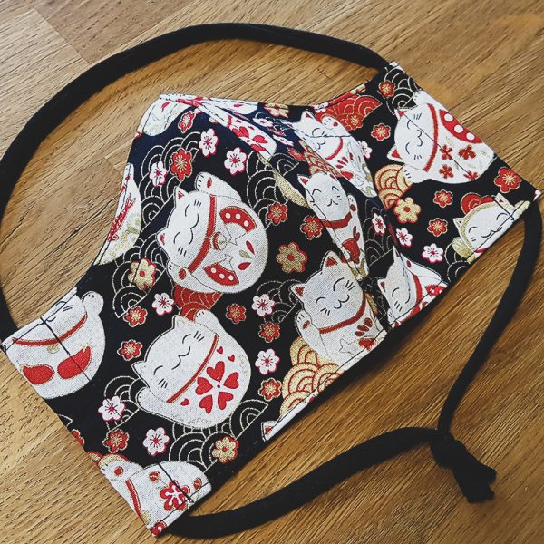 Fabric facemask with lucky cats print on black background